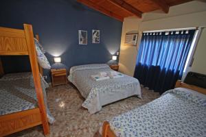 a bedroom with two beds and blue walls at Las Cabañas in Colorado River +30 photos
