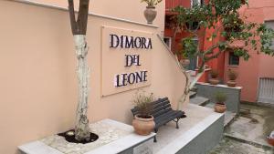 a bench sitting in front of a building with a sign at Dimora del Leone Gaeta in Gaeta