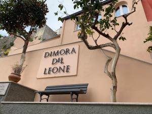 a sign on the side of a building with a bench at Dimora del Leone Gaeta in Gaeta