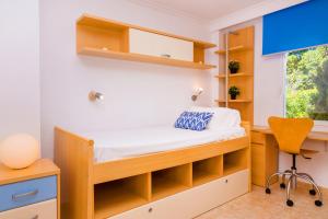a bedroom with a bed and a desk and a chair at Salonica Duplex I Penthouse Javea Arenal by Rock Rentals in Jávea +24 photos