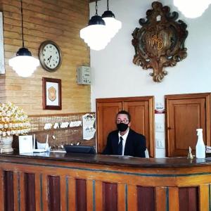 a man with a beard sitting at a bar at Pousada Araujo Bazilio in Tiradentes