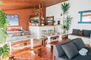 a living room with a couch and a bar at Surf Vilas by Laneez Ericeira in Ericeira
