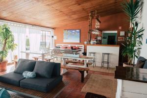 a living room with a couch and a table at Surf Vilas by Laneez Ericeira in Ericeira