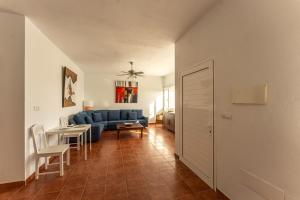 a living room with a blue couch and a table at HOTEL RURAL FINCA LA CALERA lanzarote in Güime