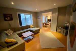 a living room with a couch and a table at Nice and central apartment in quiet area in Ålesund