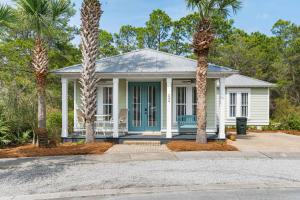 a house with palm trees in front of it at 248 Beach Bike Way in Inlet Beach