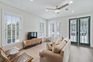a living room with a couch and a tv at 248 Beach Bike Way in Inlet Beach
