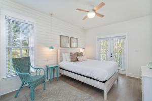 a bedroom with a bed and a table and chairs at 248 Beach Bike Way in Inlet Beach +25 photos