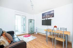 a living room with a couch and a table at Dagenham Self catering House for Larger Groups with Free Parking in Dagenham