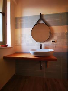 a bathroom with a sink and a mirror on a counter at La Dolce Dimora in Praia a Mare