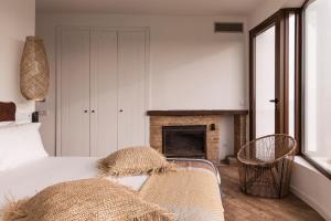 a bedroom with a bed and a fireplace at Quinta do Freixo in Benafim +33 photos