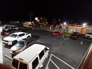a parking lot with cars parked in a parking lot at Relax Inn Silver Springs in Silver Springs +9 photos
