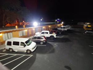 a group of cars parked in a parking lot at night at Relax Inn Silver Springs in Silver Springs