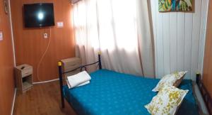 En eller flere senger på et rom på Hostal Mi Maravilla