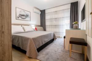 Кровать или кровати в номере Apartmani IVA