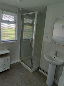 a bathroom with a shower and a sink at The Little Retreat in Dartmouth