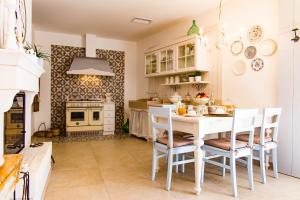 a kitchen with a white table and chairs at iannet in Alberobello