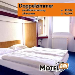 a bed in a hotel room with a poster for aartment at Motel 24h Köln in Frechen