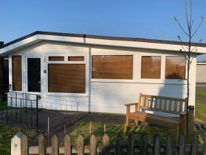 a white trailer with a bench in front of it at Dartmouth 2 Bed Detached Chalet Number 144 in Dartmouth