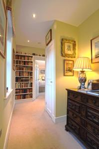 a home library with a desk with a lamp on it at Ingram House Bed & Breakfast in Alnwick