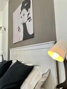 a bedroom with a black and white picture above a bed at Simons Apartments in Sliema