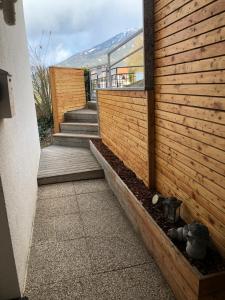 a building with wooden walls and stairs next to a building at Ferienwohnung Tirol in Landeck