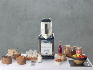 a blender sitting on top of a table with food at Kyriad Combs-La-Ville - Senart in Combs-la-Ville