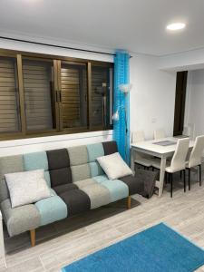 a living room with a couch and a table at Beach House Tajao in La Jaca