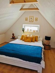 a bedroom with a large bed with a blue blanket at Sepa Puhkekeskus in Käina