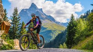 a person riding a bike on a mountain road at Hotel Pettneuerhof in Pettneu am Arlberg