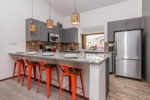 a kitchen with a large island with orange bar stools at Helios 11N in Mammoth Lakes