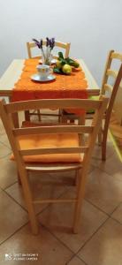 a wooden table with a bowl of vegetables on it at Studios Ana Mari in Komiža