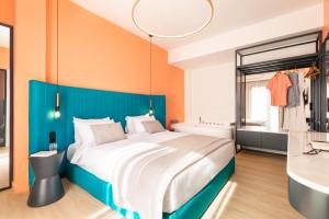 a bedroom with a large bed and a bath tub at COLORS Hotel Athens in Athens