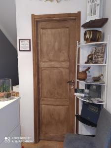 a wooden door in a room with a shelf at Rio Groppo Guesthouse in Manarola