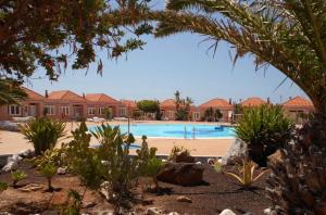 a swimming pool in a resort with houses and trees at Fuerte Casa in Costa de Antigua
