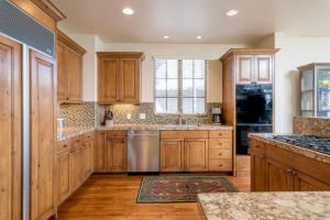 a kitchen with wooden cabinets and stainless steel appliances at Crown Ranch 4 in Sun Valley