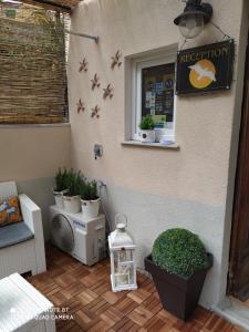 a patio with a sign on the side of a building at Rio Groppo Guesthouse in Manarola