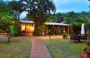 a house with a wooden walkway in front of it at Pousada Cheiro Verde Noronha in Fernando de Noronha
