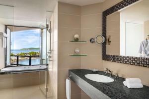 a bathroom with a sink and a mirror at Shangri-La Tanjung Aru, Kota Kinabalu in Kota Kinabalu
