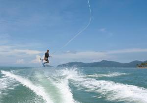a man riding a wave on a water board at Shangri-La Tanjung Aru, Kota Kinabalu in Kota Kinabalu