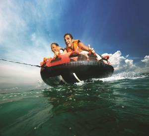 a man and a child in a boat in the water at Shangri-La Tanjung Aru, Kota Kinabalu in Kota Kinabalu
