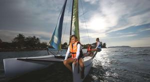 two girls sitting on a sail boat in the water at Shangri-La Tanjung Aru, Kota Kinabalu in Kota Kinabalu