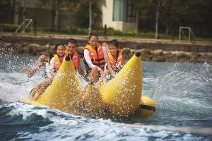 a group of people riding on a raft in the water at Shangri-La Tanjung Aru, Kota Kinabalu in Kota Kinabalu
