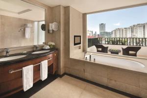 a bathroom with two sinks and a large mirror at Shangri-La Jakarta in Jakarta