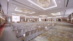 a large room with rows of chairs and a stage at Shangri-La Jakarta in Jakarta