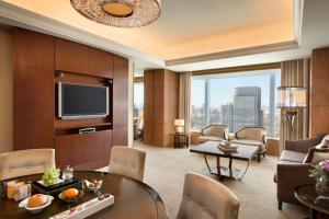 
a living room filled with furniture and a tv at Shangri-La Tokyo in Tokyo
