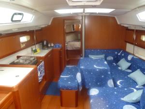 a room with a blue couch in a kitchen at Le Vele Residence Sailing Boat in Loano