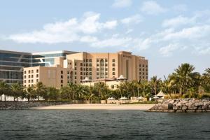 a resort from the water with a beach and buildings at Traders Hotel, Abu Dhabi in Abu Dhabi