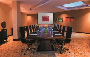 a large conference room with a long table and chairs at Traders Hotel, Abu Dhabi in Abu Dhabi +37 photos