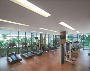 a gym with treadmills and ellipticals in a building at Shangri-La Chiang Mai in Chiang Mai